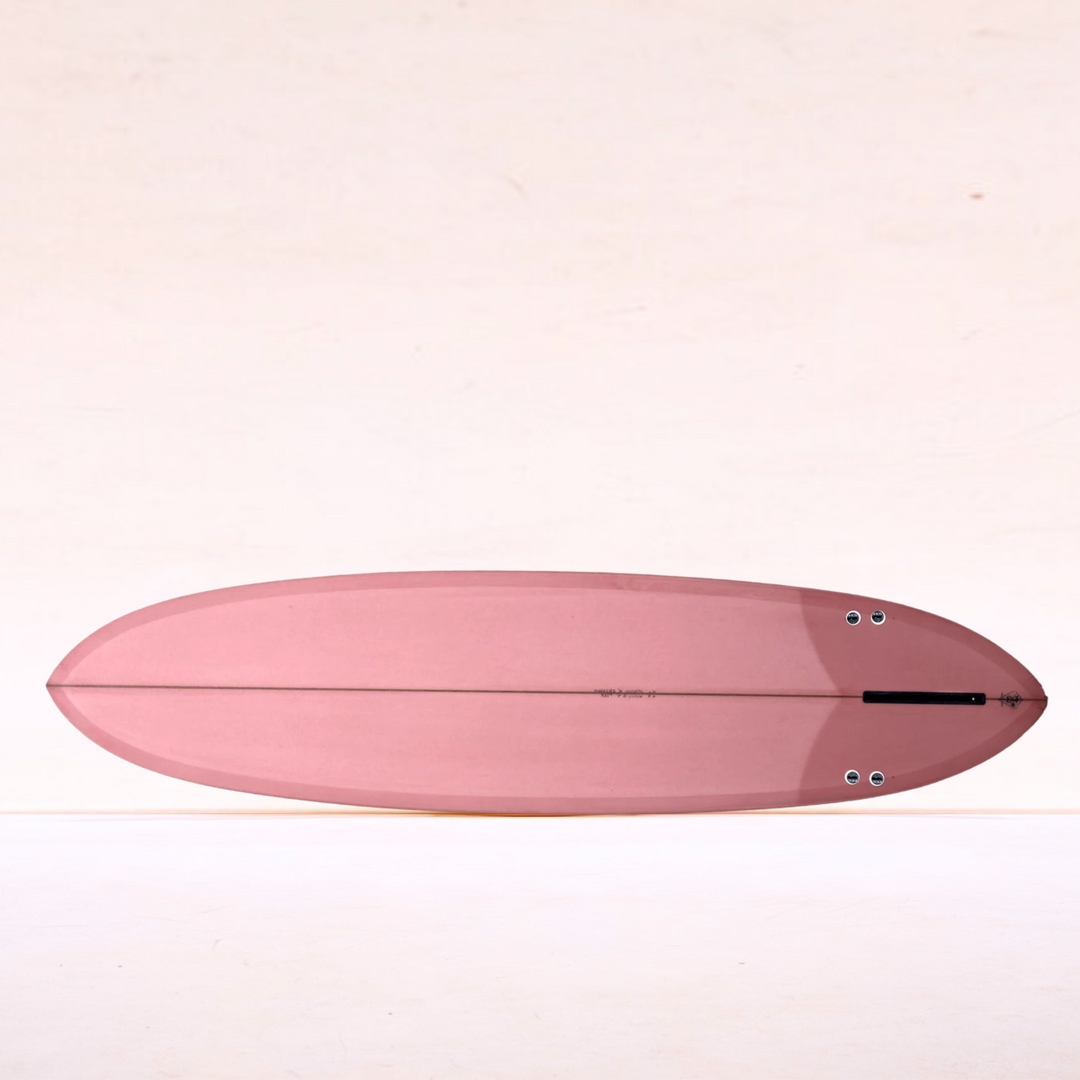 Ryan Lovelace Lovemachine Thick Lizzy mini-glider surfboard, full resin tint in dusty pink, showing refined outline and tri-plane bottom.